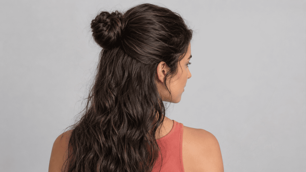 Natural-texture half-up bun hairstyle for humid August days