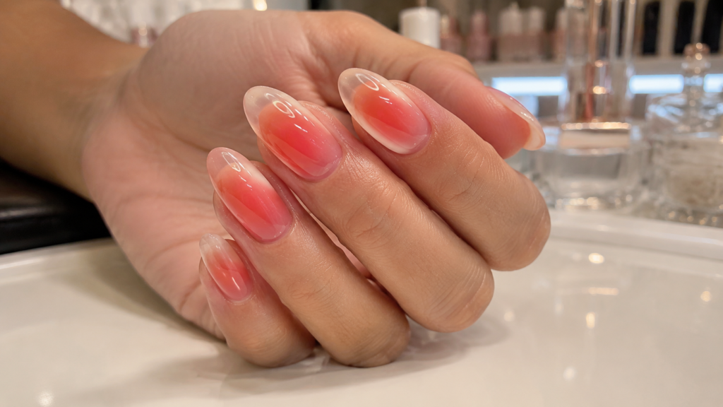 Glossy jelly aura nails with translucent glowing color gradients.