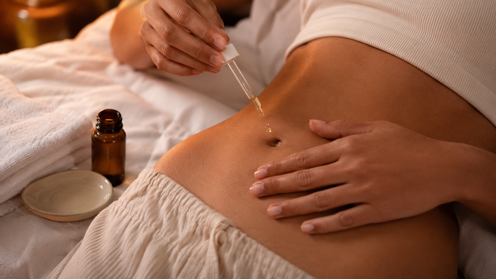 Woman practicing the Belly Button Oiling Ayurvedic Beauty Practice before bed.
