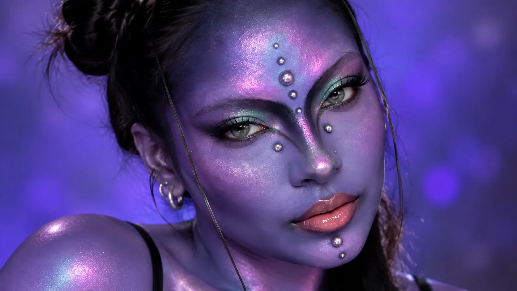 Purple alien makeup look with futuristic face details, glowing skin, and creative fantasy beauty design