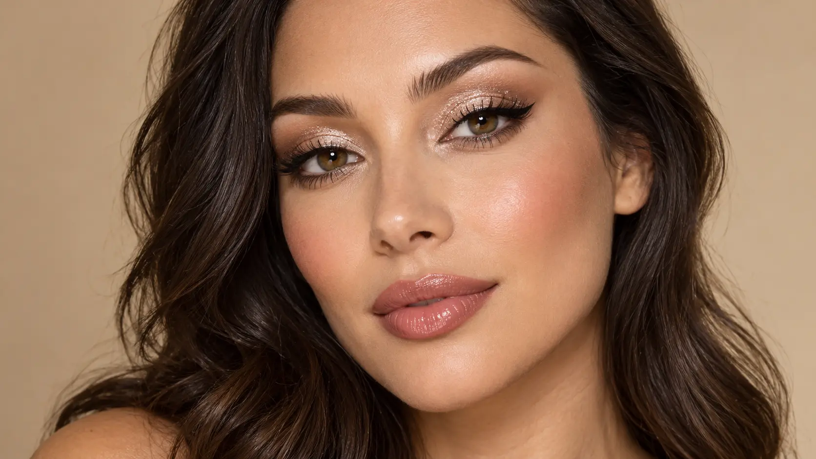Champagne shimmer eye makeup with soft brown eyeshadow, winged eyeliner, and glossy nude lips.
